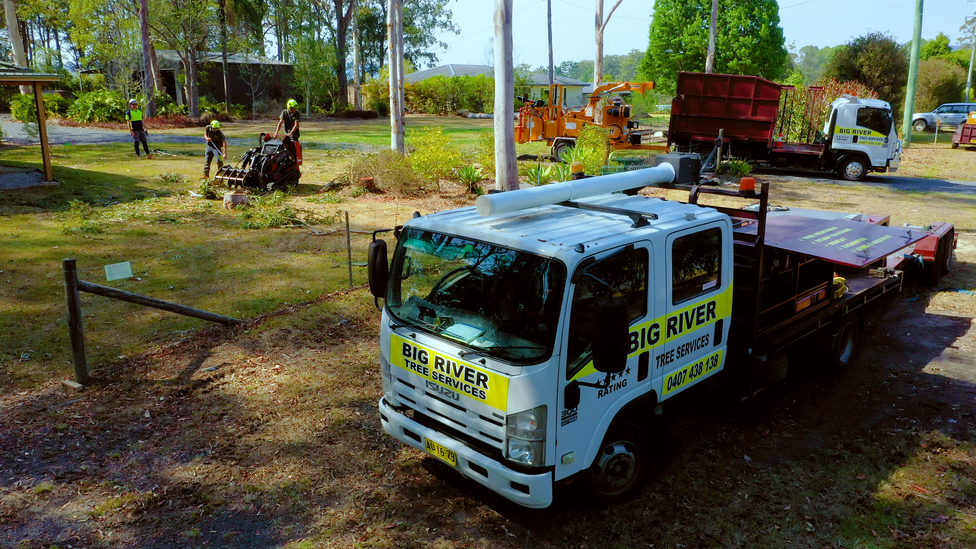 Big River Tree Services vehicles and crew on a local property